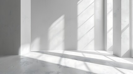Fototapeta premium Interior space with white walls and sunlight streaming through windows creating shadows on the floor