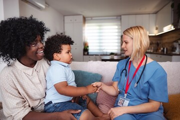 Fototapeta premium Caring doctor listening to family concerns