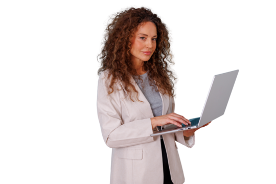 Confident corporate woman with curly hair typing on a notebook computer, managing business tasks, and communicating online
