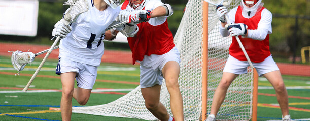 Lacrosse Match with Defender knocking back his Competitor by the goal
