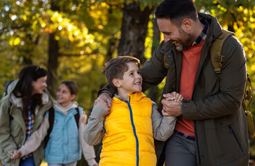 Obraz premium Family enjoys hiking together in a serene forest in autumn