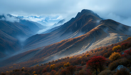 Mist shrouded mountain saddle with twisting ridgelines and autumn foliage hues