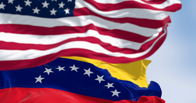 Venezuela and US national flags waving in the wind on a clear day - Powered by Adobe