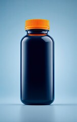 Dark blue bottle with orange cap, studio shot