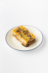 Eggplant moussaka slice with minced meat and cheese on white plate, studio shot