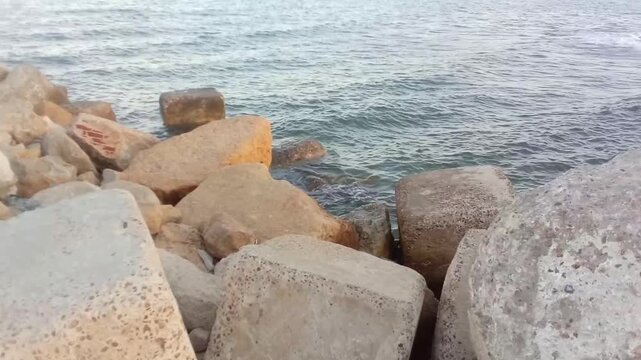 A great view of some rocks, the Mediterranean Sea and the sky is next to Masoud Well in Sidi Bishr, Alexandria, Egypt. The view is in the morning. Masoud Well may be an ancient Greek tomb.