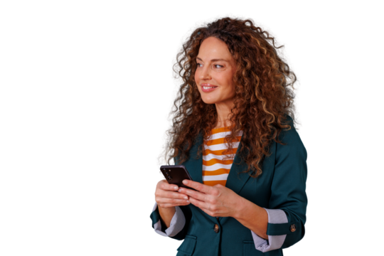 Businesswoman with curly hair smiling and looking away, actively using a smartphone, connecting and communicating digitally