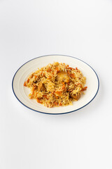 Chicken pilaf with basmati rice and carrots on plate, studio food photo on white