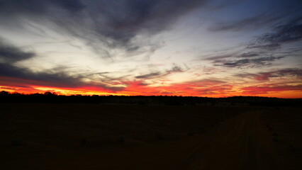 Fiery Red Sunset with Dramatic Horizon
