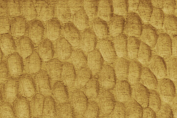 Textured yellow wooden surface with carved oval patterns and visible wood grain. Abstract texture background ideal for design, craft, or natural texture themes.