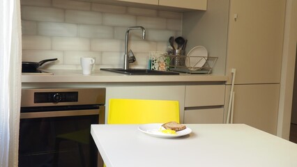 Woman standing by the stove in the kitchen, cooking and smelling the nice aromas from her meal in a pot. woman preparing tasty and healthy food for her family in the kitchen at home