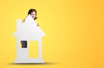 Lovely laughing little child girl playing with toy house