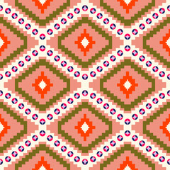 Peach and olive ethnic diamond mosaics accented with bright orange centers and playful dot rings for cozy decorative fabric design