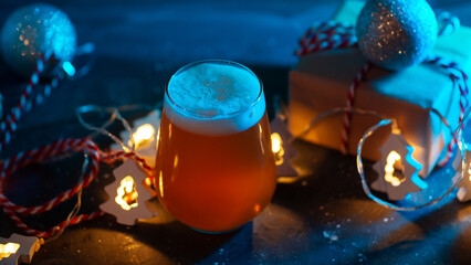 Christmas beer ale on a table with garland, balls and a gift box