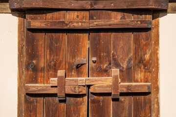 Traditional Wooden Door Panels with Rustic Locking Hardware