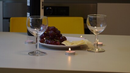 Romantic couple enjoying dinner at home, concept love, relationship and romantic, happy couple celebrating and making cheers with glasses of red wine. girl eats grapes and cheese, Valentine's Day