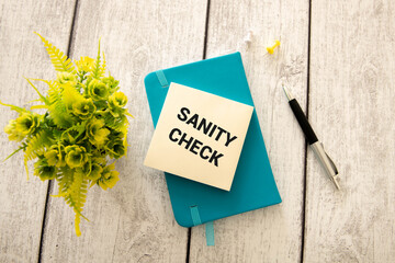 Naklejka premium text Sanity check on white business card.