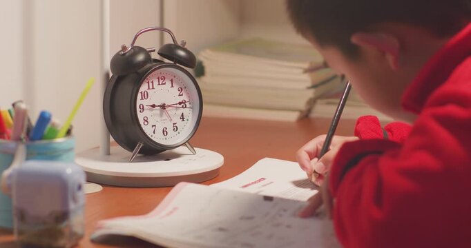 The children are doing their homework very late.