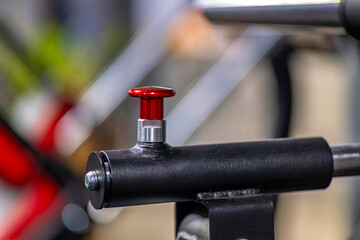A close up of a bike handlebar with a red knob