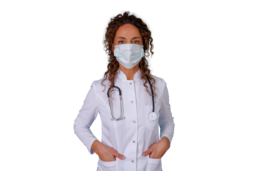 Female doctor wearing protective face mask and stethoscope, standing with hands in pockets, looking at camera