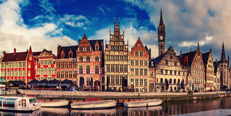 Ghent city historical center, tourists boats and colorful buildings on Leie river bank, Belgium
