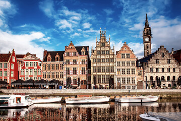 Ghent city historical center, tourists boats and colorful buildings on Leie river bank, Belgium