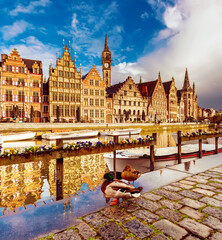 Ghent city historical center, tourists boats and colorful buildings on Leie river bank, Belgium