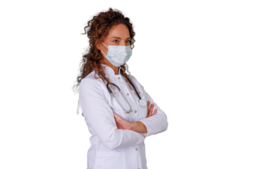 Woman doctor wearing a protective face mask and white coat with a stethoscope, standing confidently with arms crossed. Transparent background