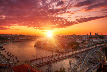 Scenic view of Porto city during sunset with a bridge over the river in Portugal.
