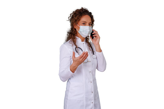 Woman doctor wearing a face mask and stethoscope, talking on a mobile phone, providing healthcare consultation