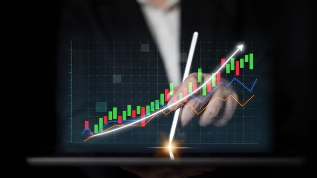 A businessman interacts with a digital display showing stock market trends and growth, illustrating financial analysis and investment strategies in a modern work environment. Impute