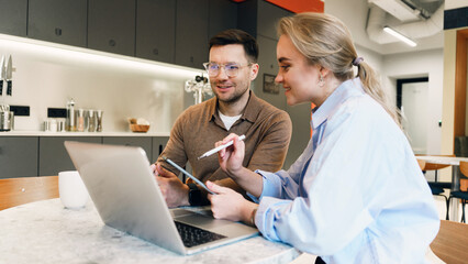 Discussion between coworkers in modern office setting