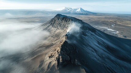 A mountain with a cloud of smoke coming from it