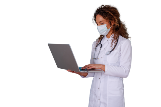 Female doctor in lab coat and face mask using laptop, providing online consultation and telemedicine service - Powered by Adobe
