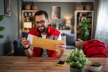 Paramedic reading good news letter at home