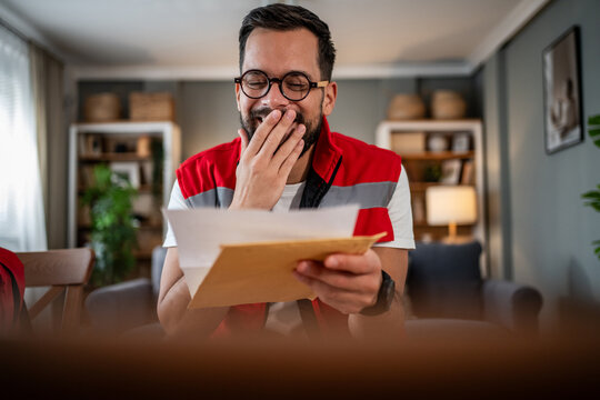 Paramedic receiving good news reading important letter at home
