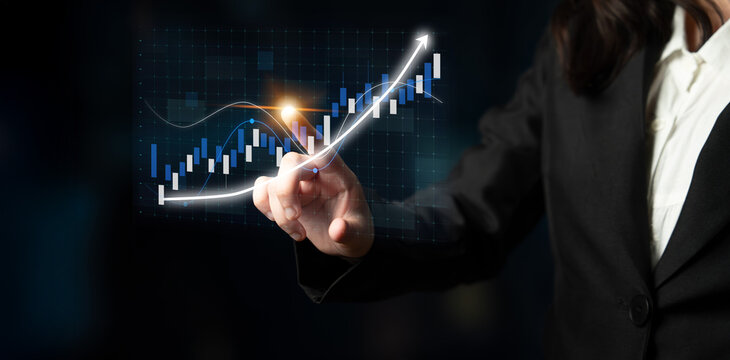 A business professional interacts with a digital touchscreen, analyzing a growth chart symbolizing financial market trends and investment strategies. Impute - Powered by Adobe