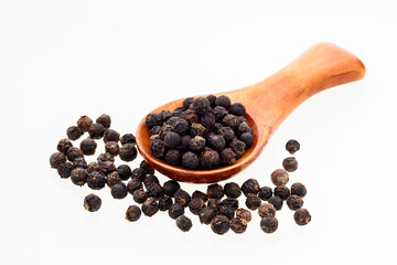 Piper nigrum - Black peppercorns in a wooden spoon