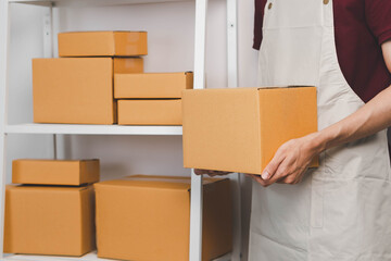 Close-up of man holding a parcel box, representing delivery service, shipping, e-commerce...