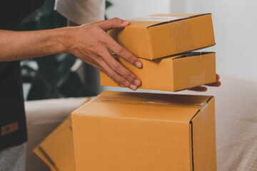 Close-up of man holding a parcel box, representing delivery service, shipping, e-commerce...