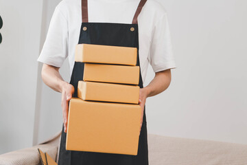 Close-up of man holding a parcel box, representing delivery service, shipping, e-commerce...