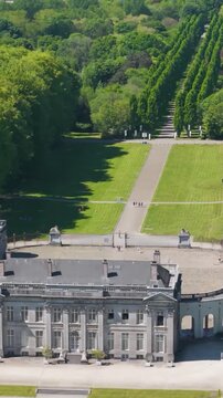 main part ch&acirc;teau seneffe green parks behind visitors walking building create lively scene to left toward right front pans aerial drone of de belgium 