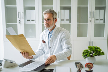 Doctor reviewing patient medical records in modern office