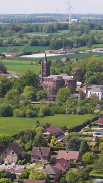seneffe town colorful buildings architecture church end visible windmills background enhance scenic to reveal pulls aerial drone back belgium showcasing beauty 