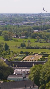 ch&acirc;teau seneffe vast area beyond buildings windmills fields town below create scenic backdrop to from left right pans aerial of de belgium 