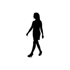 Silhouette of a woman in a dress and heels walking against a white background in a studio shot view