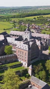 moves town's layout alongside floreffe abbey belgium perspective unique local architecture to revealing from left right circling aerial shot view 