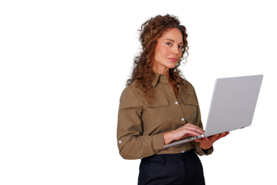 Businesswoman standing, holding and working on laptop, looking at camera, displaying confidence and professionalism