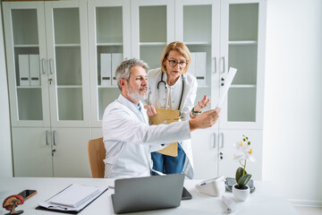 Medical team collaborating on patient report in a hospital setting