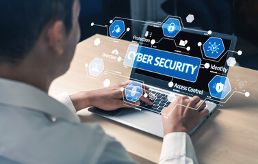 A professional engages with essential cyber security concepts displayed on a laptop, highlighting key digital graphics that represent modern workflows and protection measures. Tessel